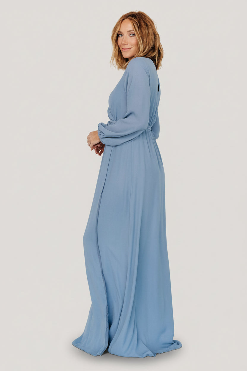 Close-up of the Breanne dress bodice in slate blue showing crossover V-neck, discreet button closure, and lined interior for coverage.
