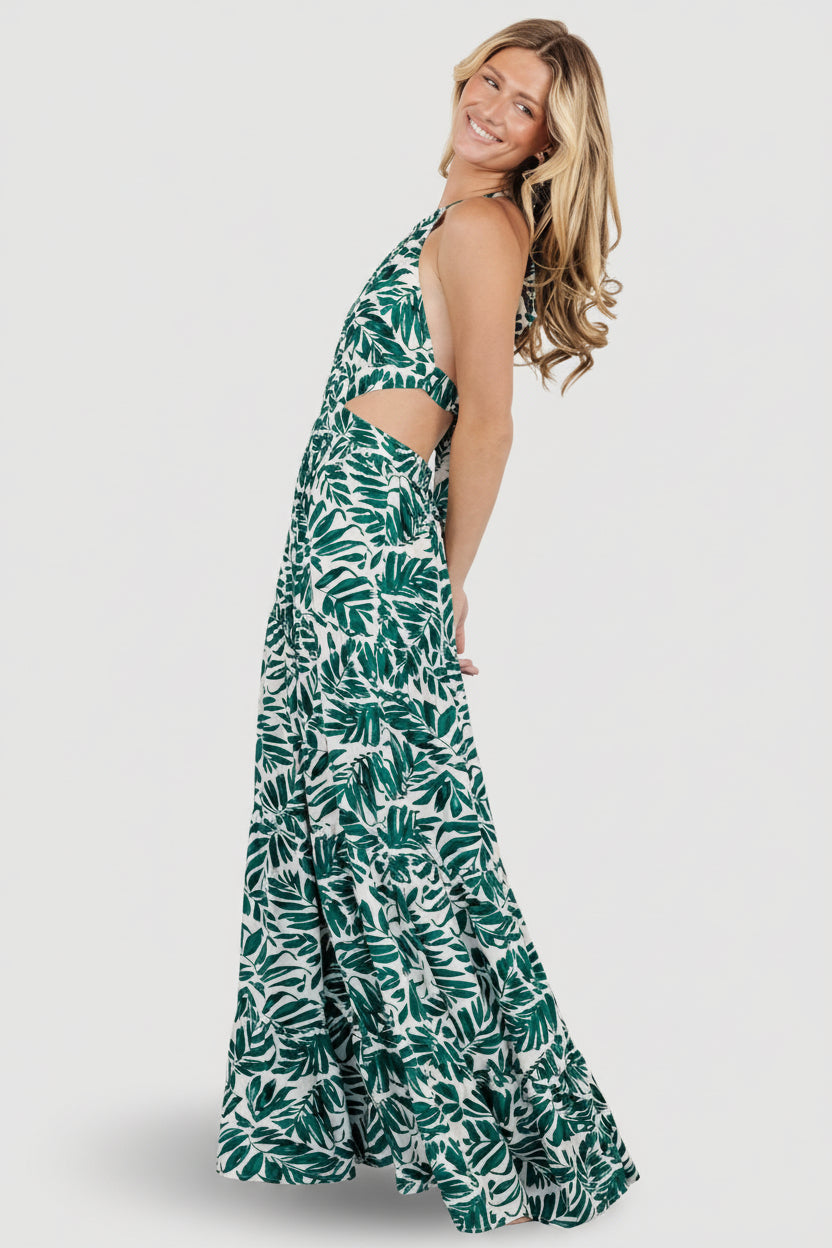Close-up of palm print on lightweight rayon fabric, cream background with deep green leaf motif and visible weave.