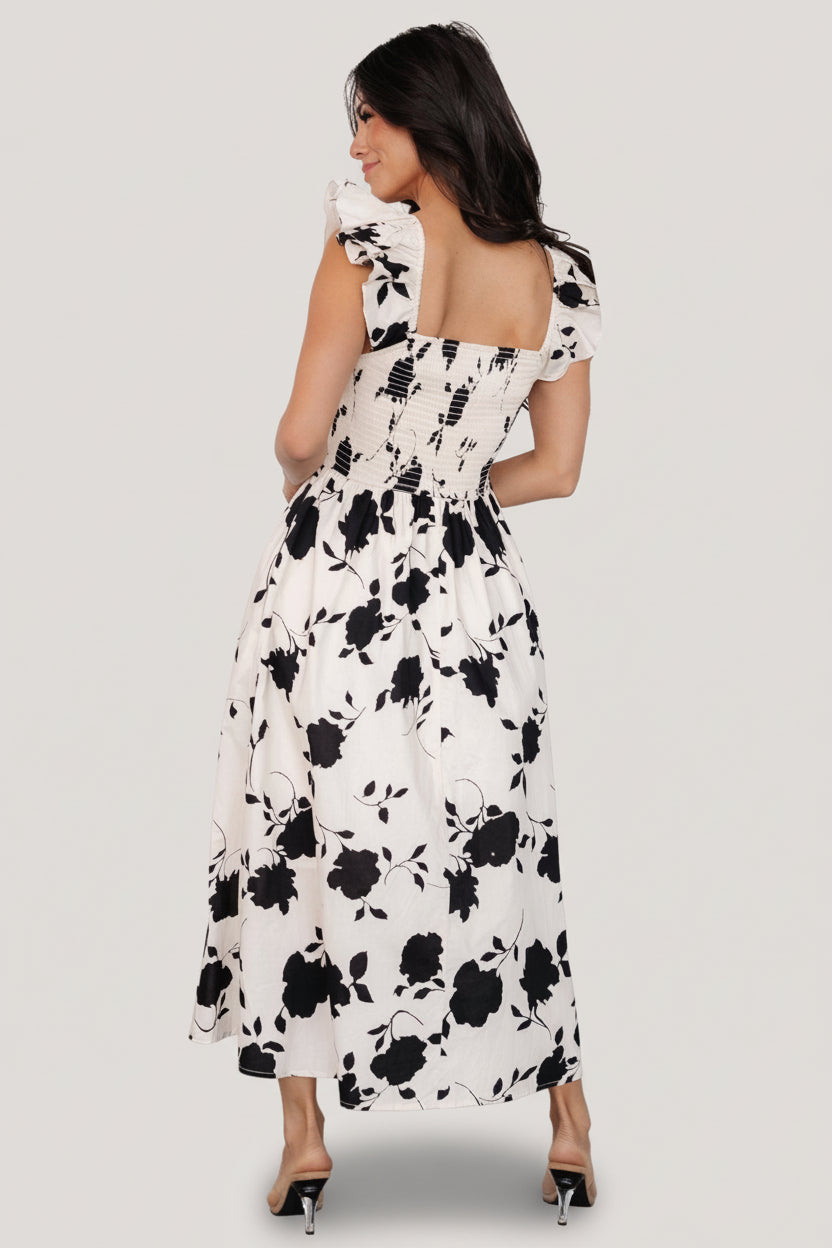 Back detail of the midi dress highlighting smocked back panel and elastic at the waist for a comfortable fit.