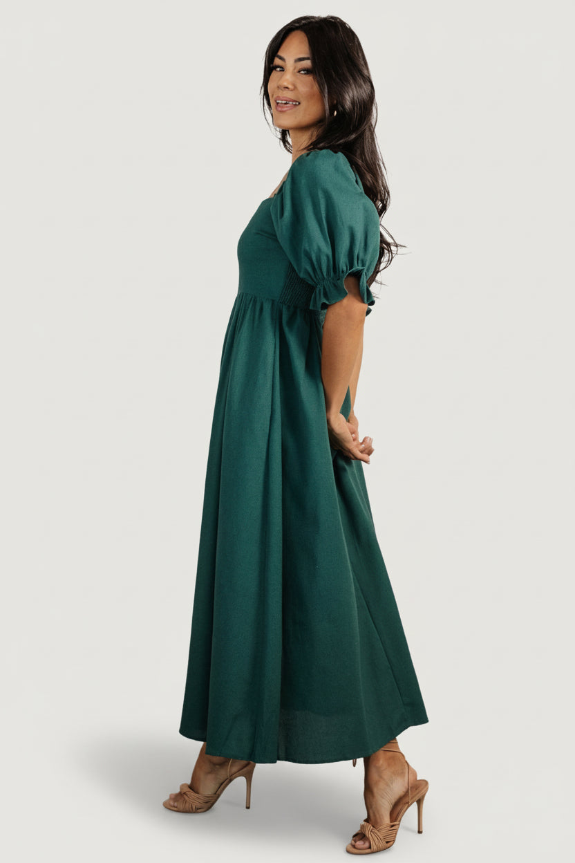 Styled look of the Evergreen Britton Midi on a model, showing midi length, square neckline, ruffle sleeves and how it pairs with sandals for daytime wear.