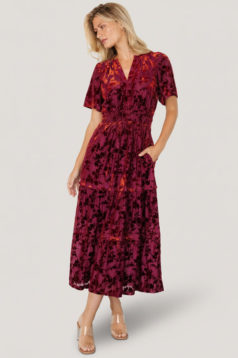 Front view of Bronwyn burnout velvet midi dress in rust floral print showing notched neckline, flutter sleeves, and smocked waist for a flattering silhouette.