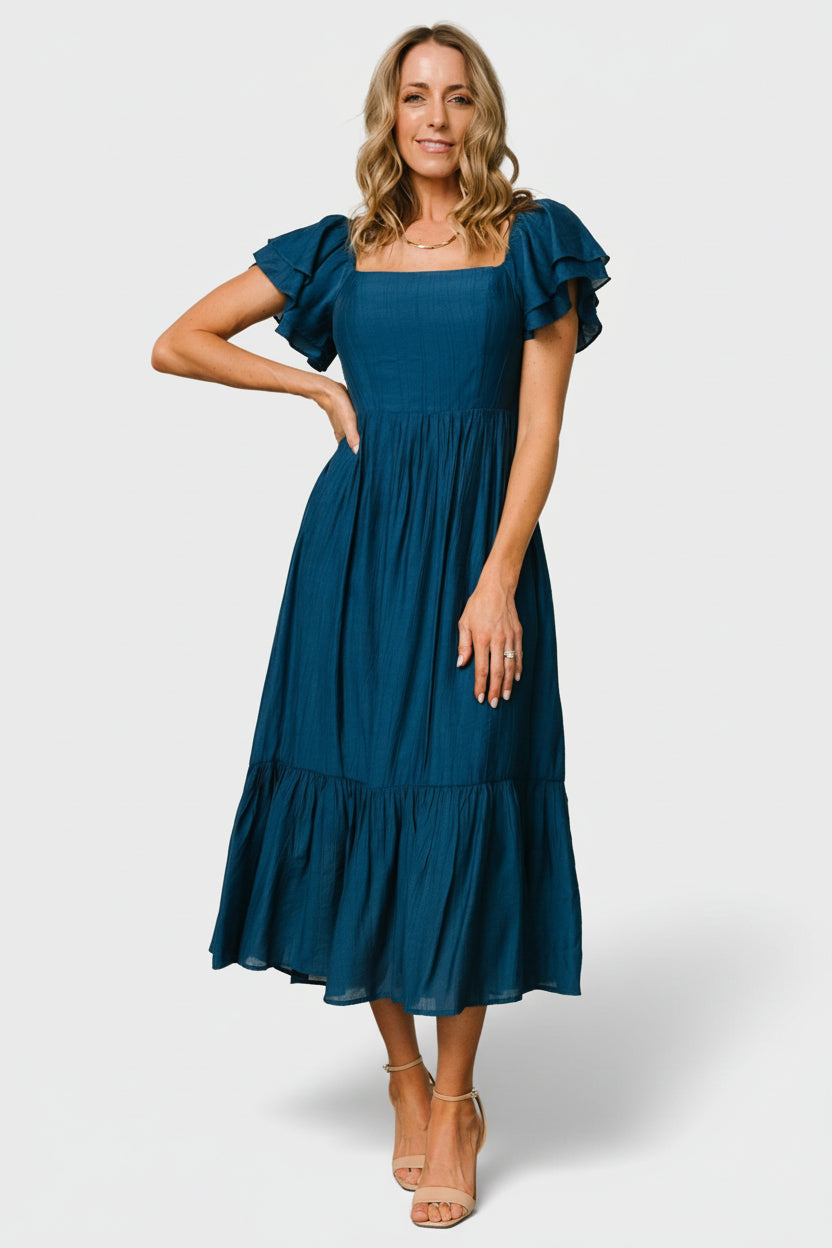 Flat-lay of Buttercup Midi Dress in deep blue, showing overall shape, smocked back detail, and layered ruffle tiers for styling reference.