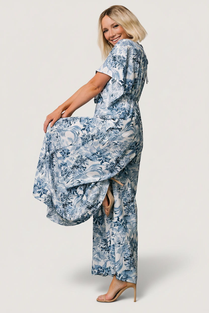 Close-up of rayon fabric and Caribbean deep blue floral print on white background, showing texture and drape