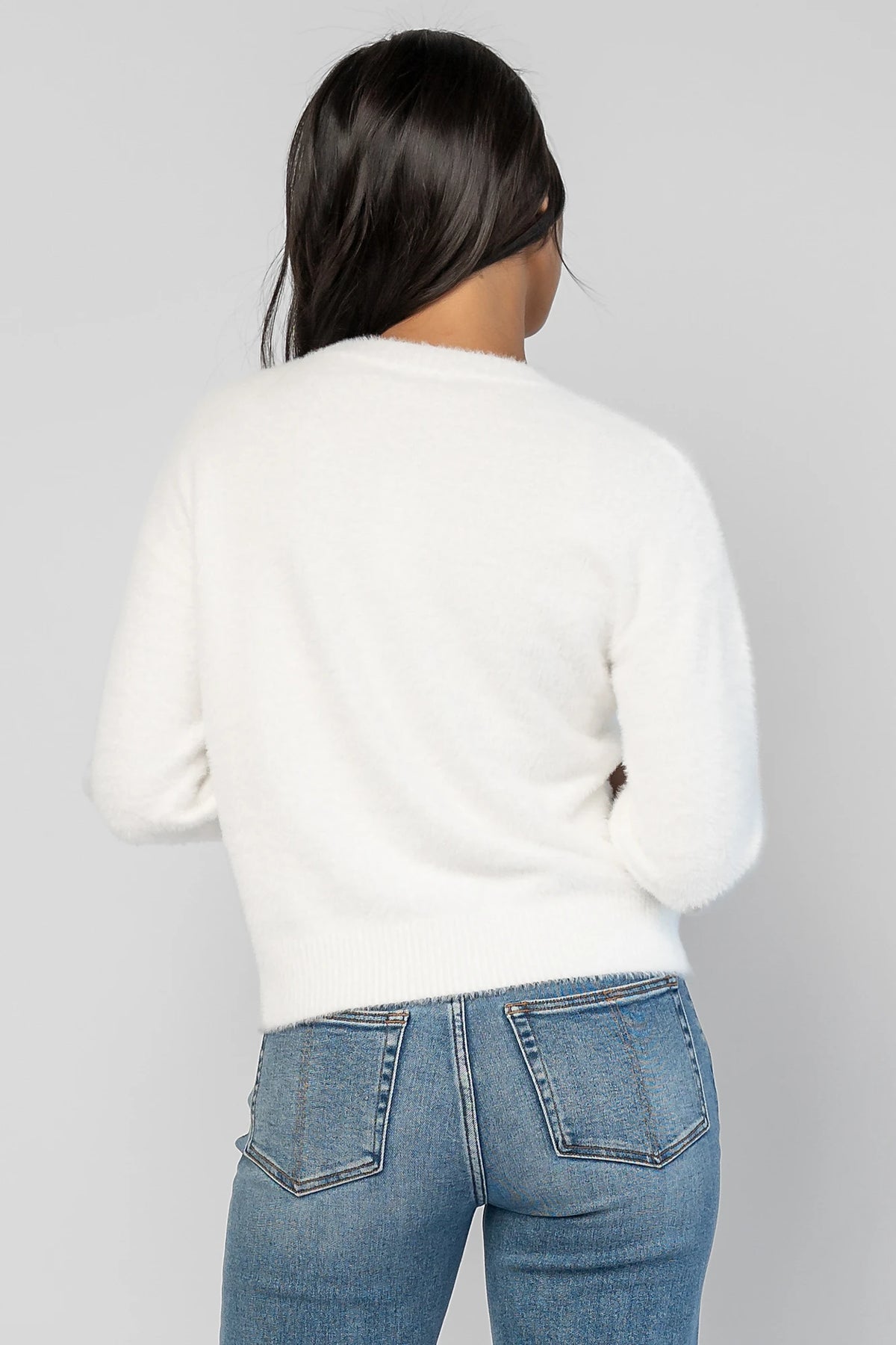 Calista Sweater Top in Off White with a round neckline, dropped shoulders, and 3/4-length sleeves.
