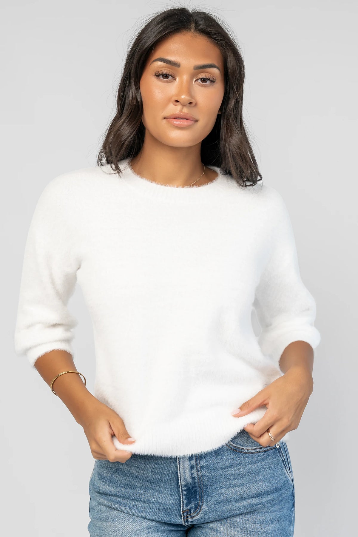Calista Sweater Top in Off White with a round neckline, dropped shoulders, and 3/4-length sleeves.