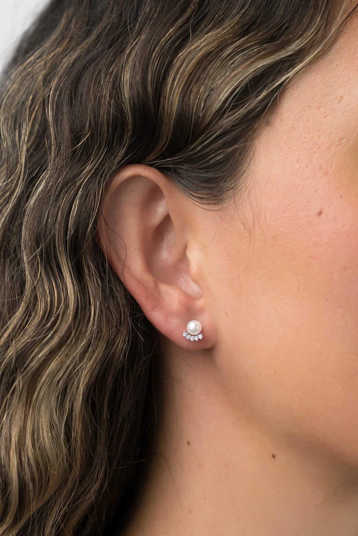 Carol Pearl Crown Stud Earrings in Silver with crown-inspired cubic zirconia and faux pearl.