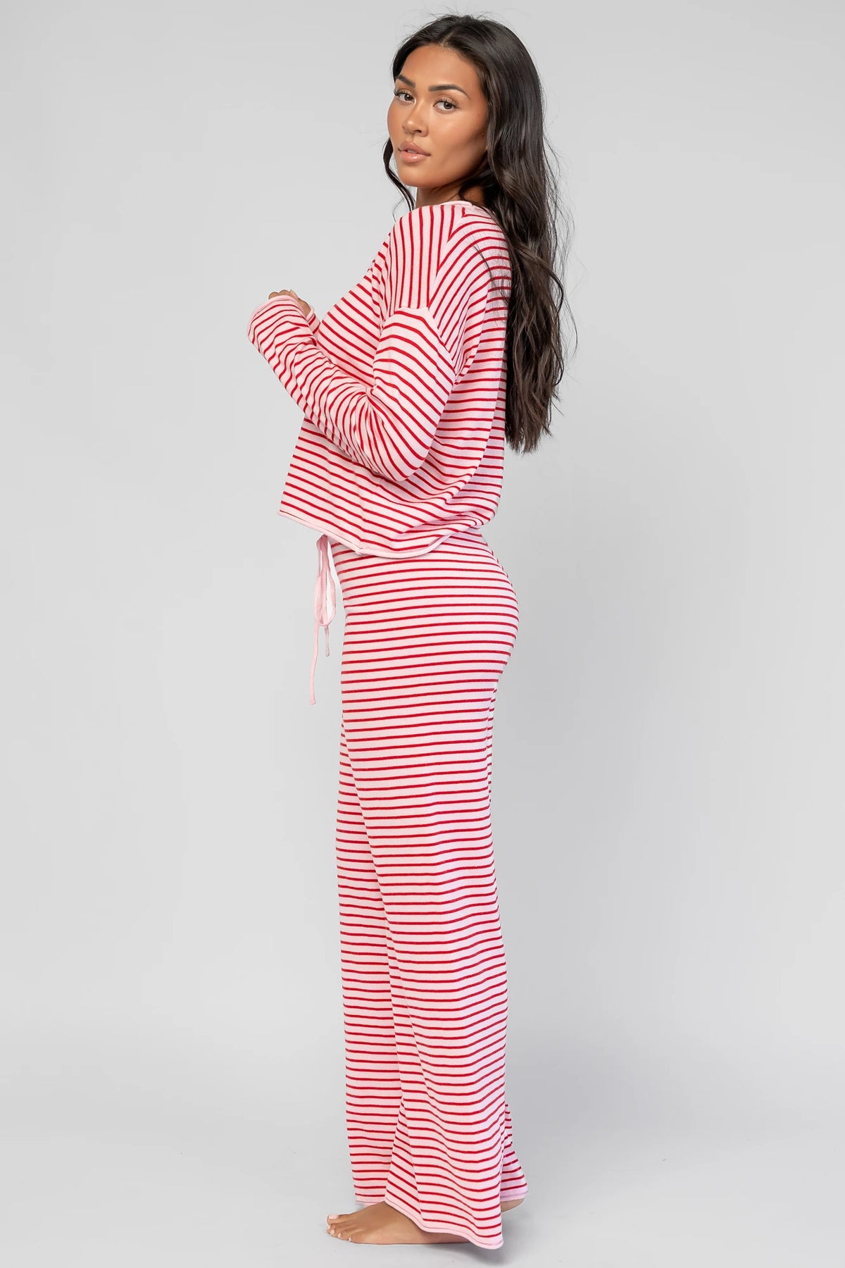 Charlene Cozy Stripe Lounge Set in Pink + Red with striped pattern and coordinating top and pants.