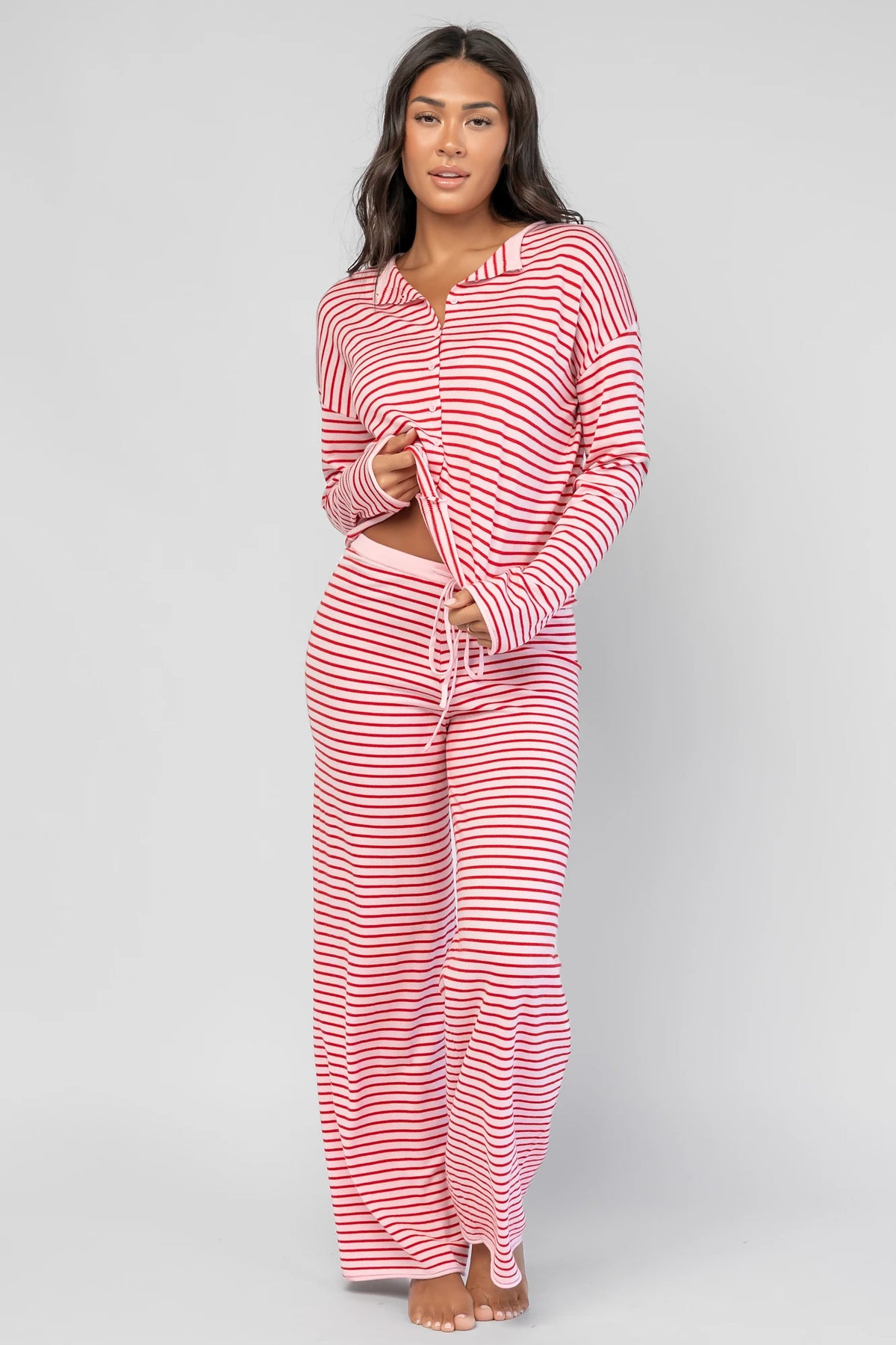 Charlene Cozy Stripe Lounge Set in Pink + Red with striped pattern and coordinating top and pants.