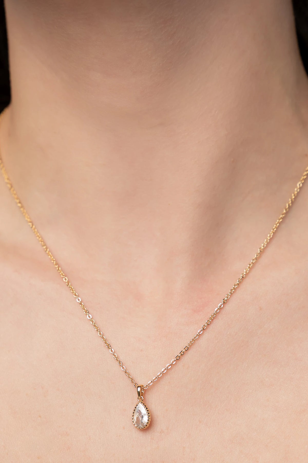 Christy Teardrop Pendant Necklace in Gold with sparkling teardrop-cut cubic zirconia pendant and delicate gold-tone chain.
