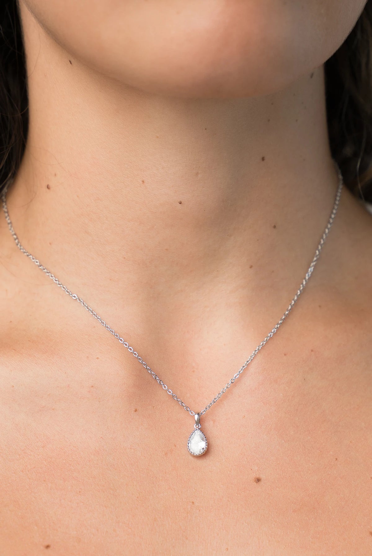 Christy Teardrop Pendant Necklace in Silver with teardrop cubic zirconia pendant and delicate chain.