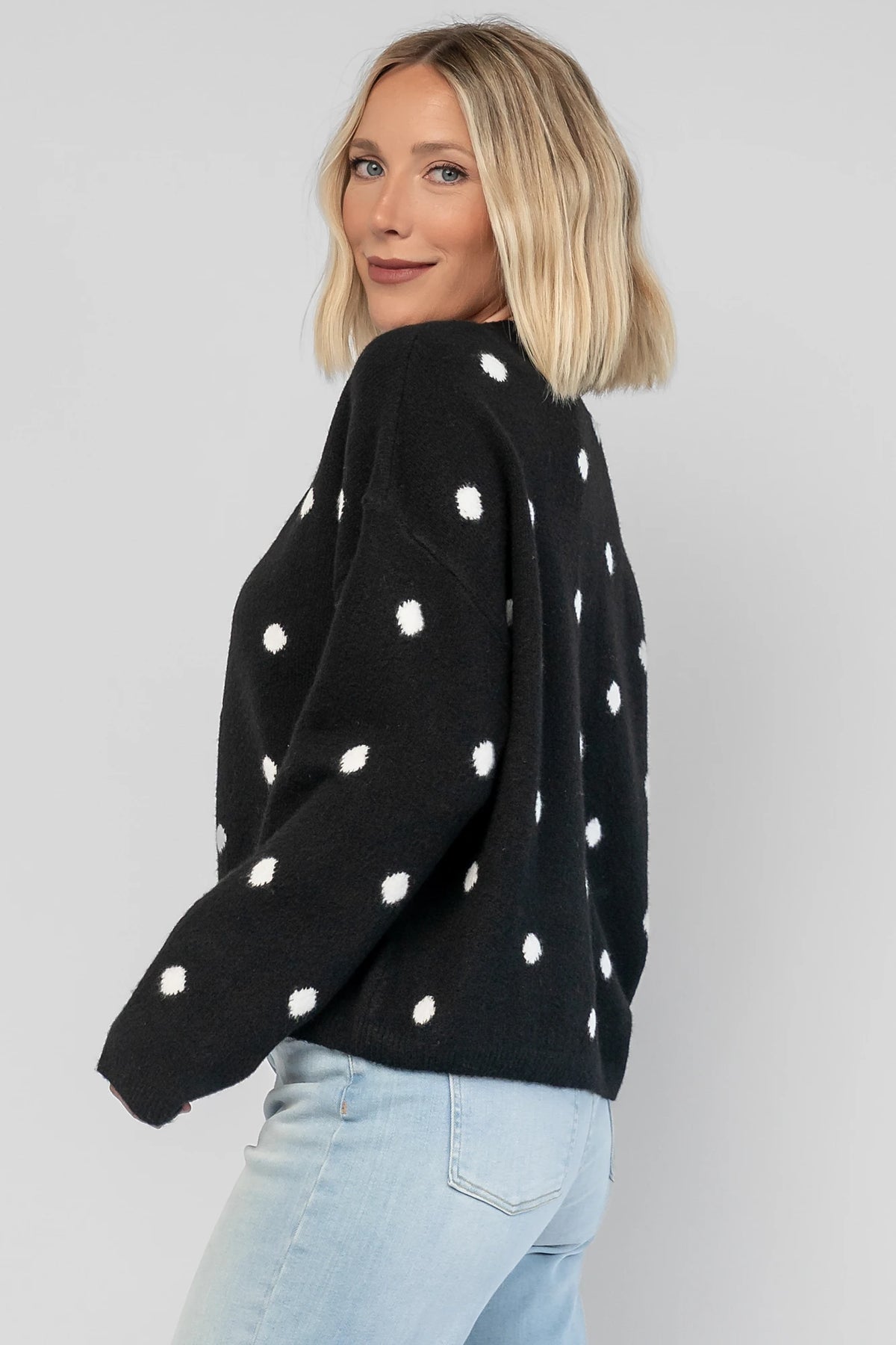 Cinder Cardigan in Black + White Dot with a button-front closure, polka-dot trim, and a relaxed knit silhouette.