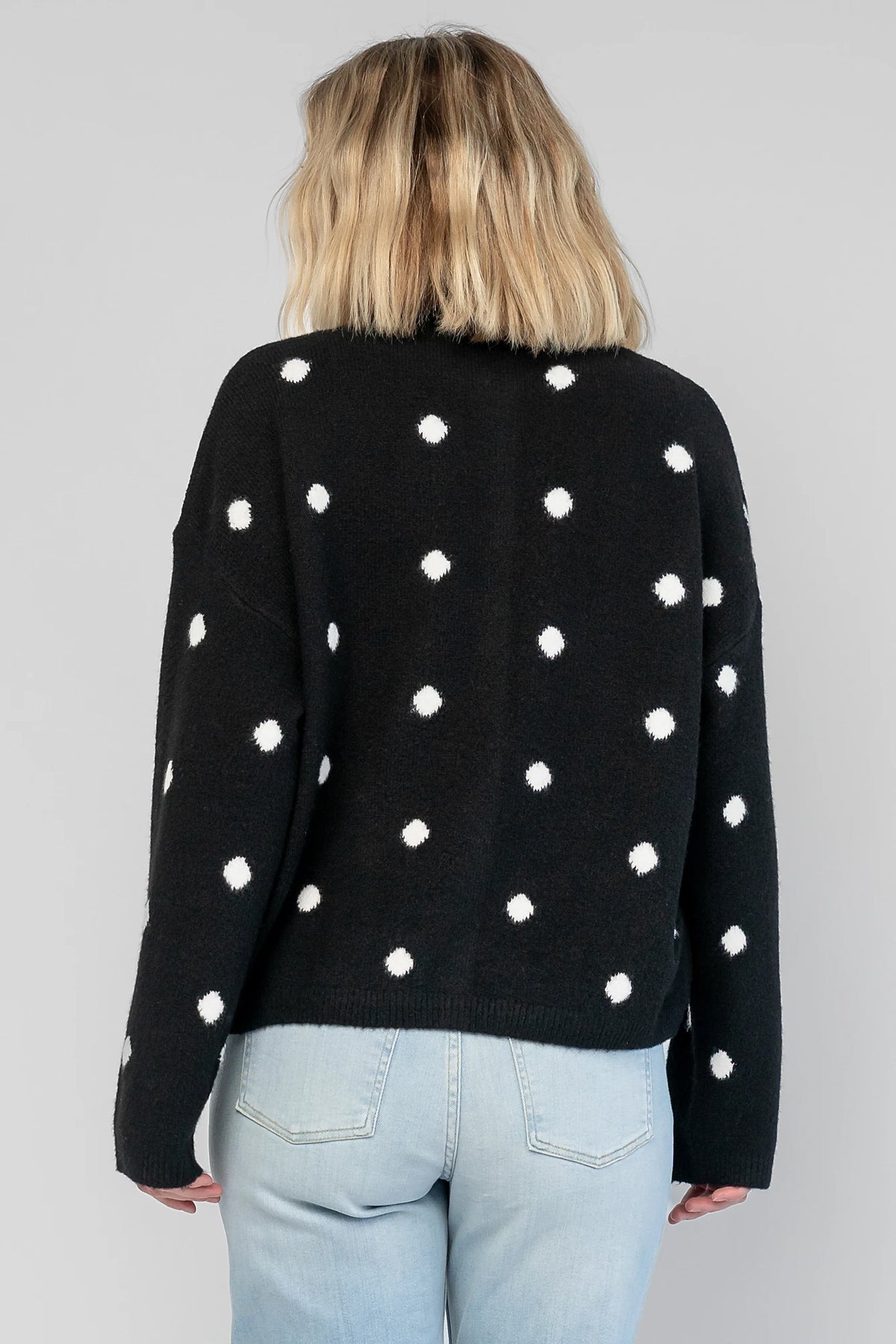 Cinder Cardigan in Black + White Dot with a button-front closure, polka-dot trim, and a relaxed knit silhouette.