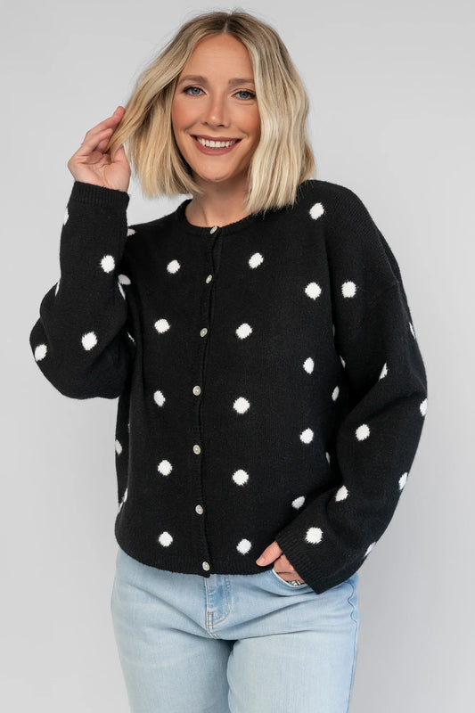 Cinder Cardigan in Black + White Dot with a button-front closure, polka-dot trim, and a relaxed knit silhouette.