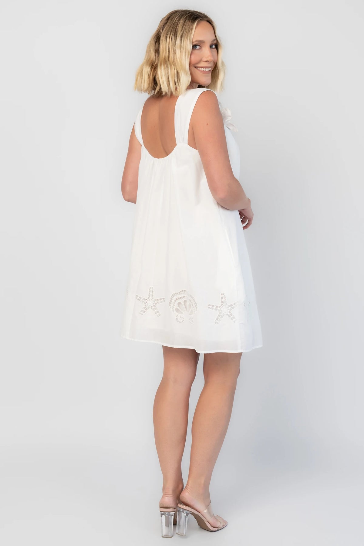 Citrus Short Dress in Off White with scoop neckline, shell and starfish cutouts, and relaxed silhouette.