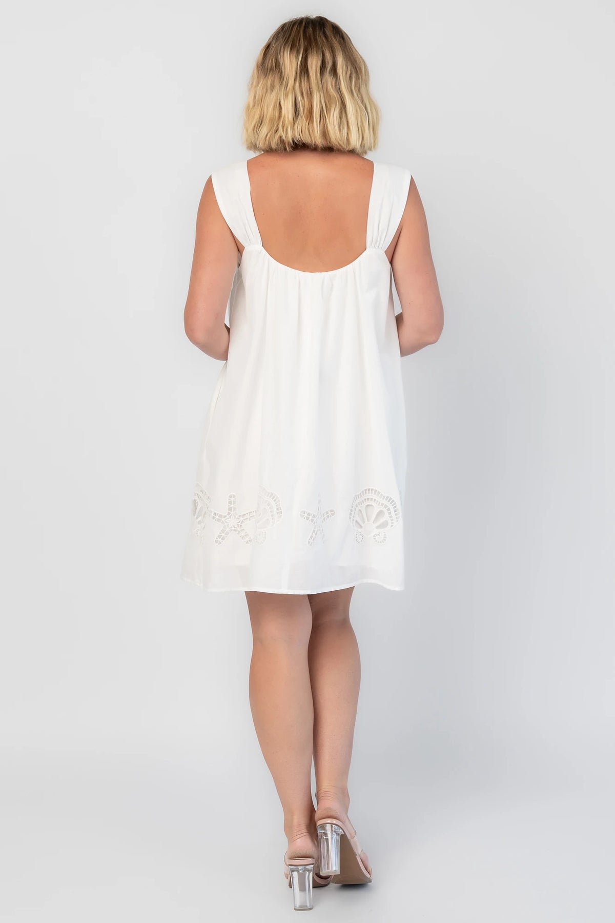 Citrus Short Dress in Off White with scoop neckline, shell and starfish cutouts, and relaxed silhouette.