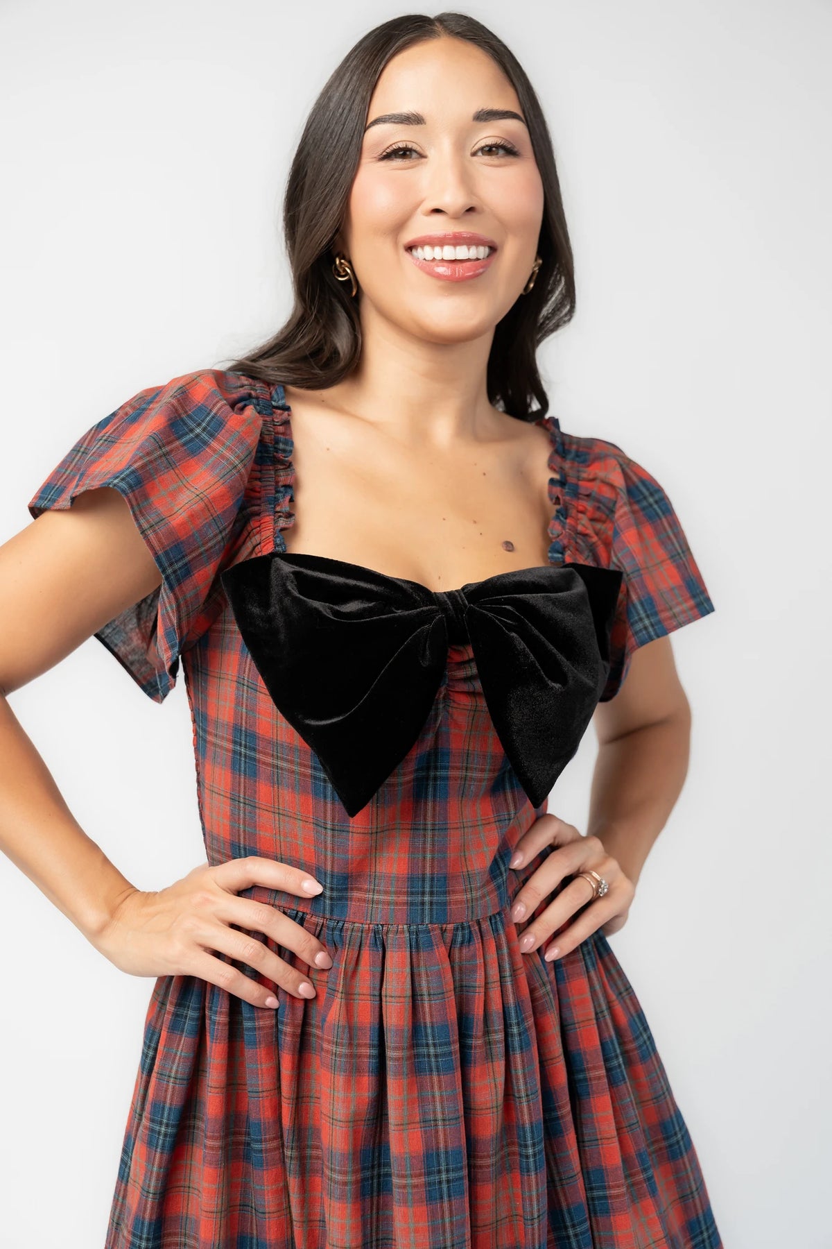 Claudine Short Dress in Plaid Multi with black velvet bow, square neckline, flutter sleeves, and gathered skirt.