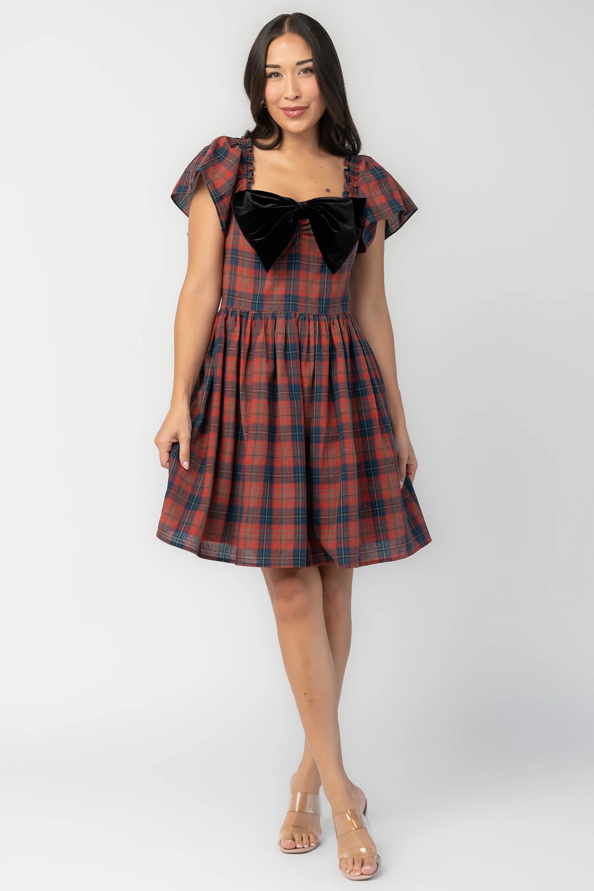 Claudine Short Dress in Plaid Multi with black velvet bow, square neckline, flutter sleeves, and gathered skirt.