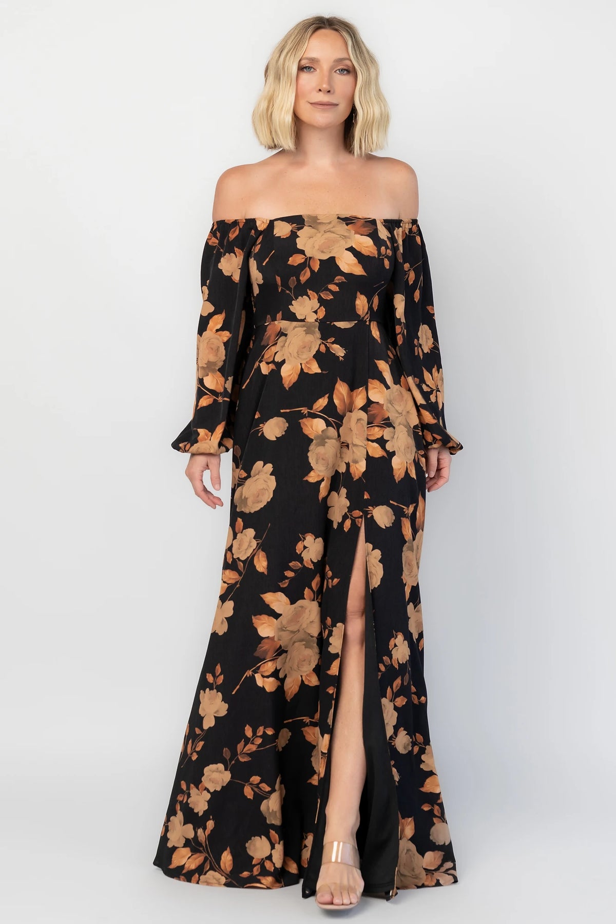 Cordelia Off Shoulder Maxi Dress in Black + Gold Floral with an off-shoulder neckline, billowy sleeves, and a leg slit.