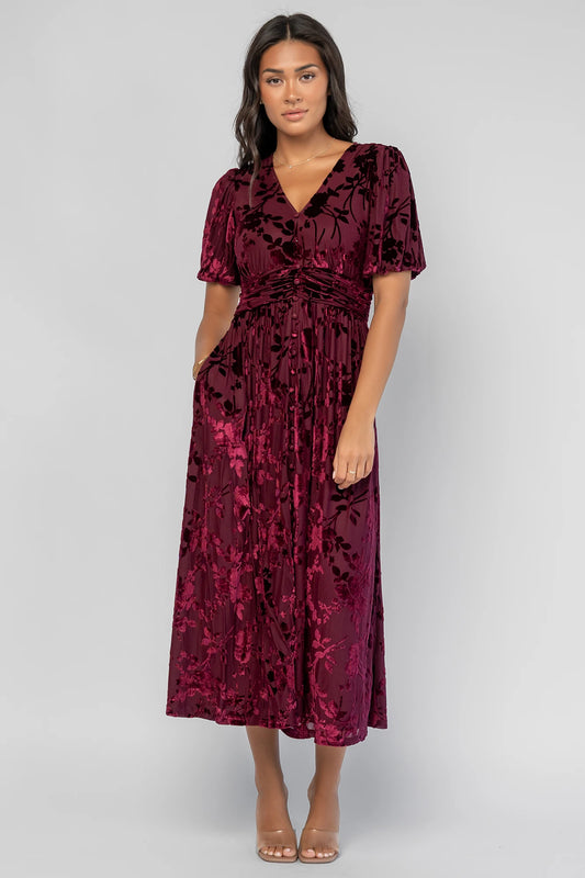 Dahlia Velvet Dress in Mulberry Floral with embossed velvet texture, a V-neckline, faux-button placket, and puff sleeves.