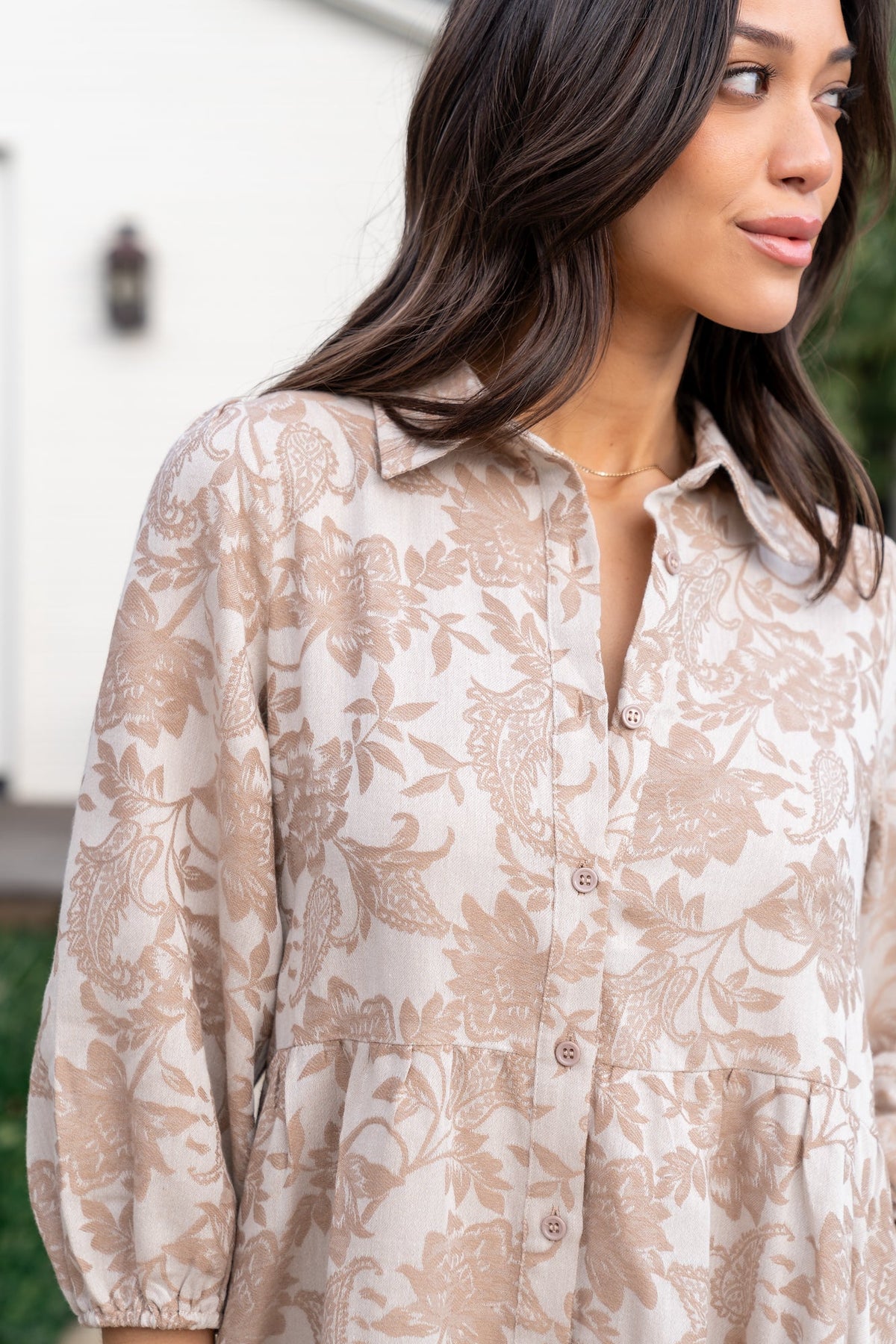 Back and movement shot of Dakota Babydoll Dress in taupe print, emphasizing tiered skirt and lightweight drape.