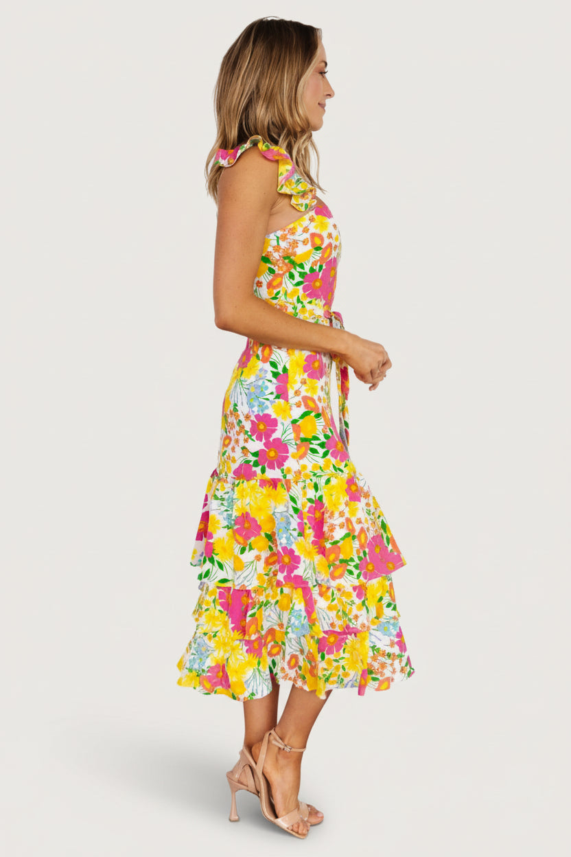Back view of tiered midi dress showing hidden zipper closure and the natural drape of layered ruffles at the hem.