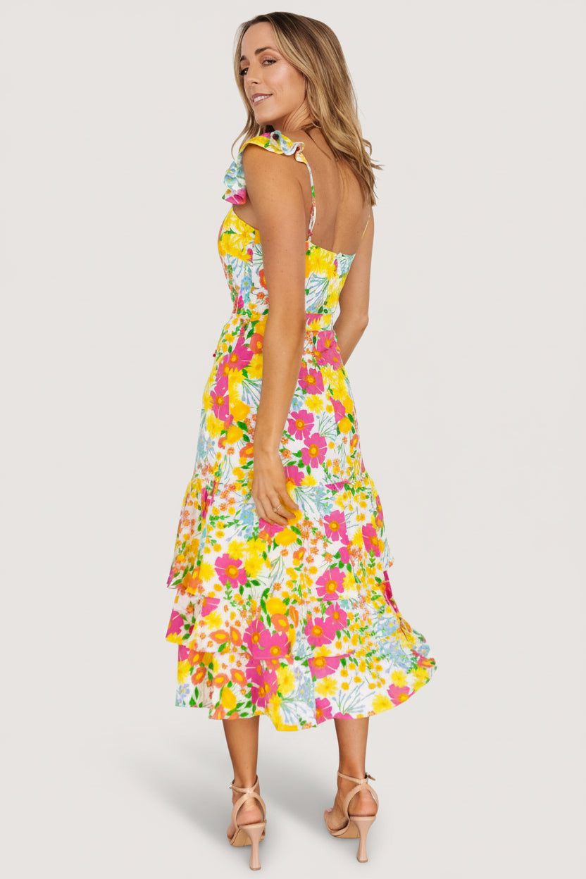 Detail shot of removable waist tie tied at the side, demonstrating how the tie shapes the waist on the tiered skirt.