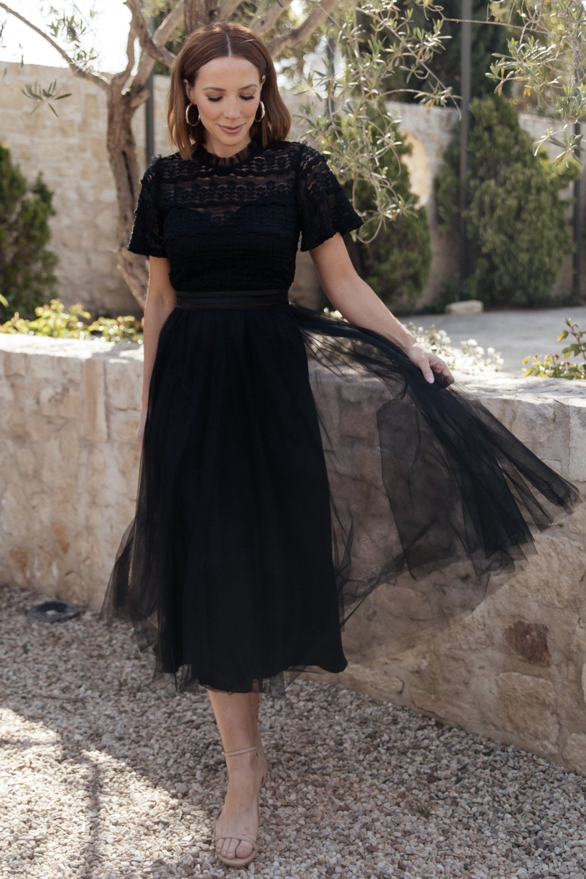 Detail shot of skirt movement and tulle layers, showing airy volume and delicate texture suitable for evening and wedding guest looks.