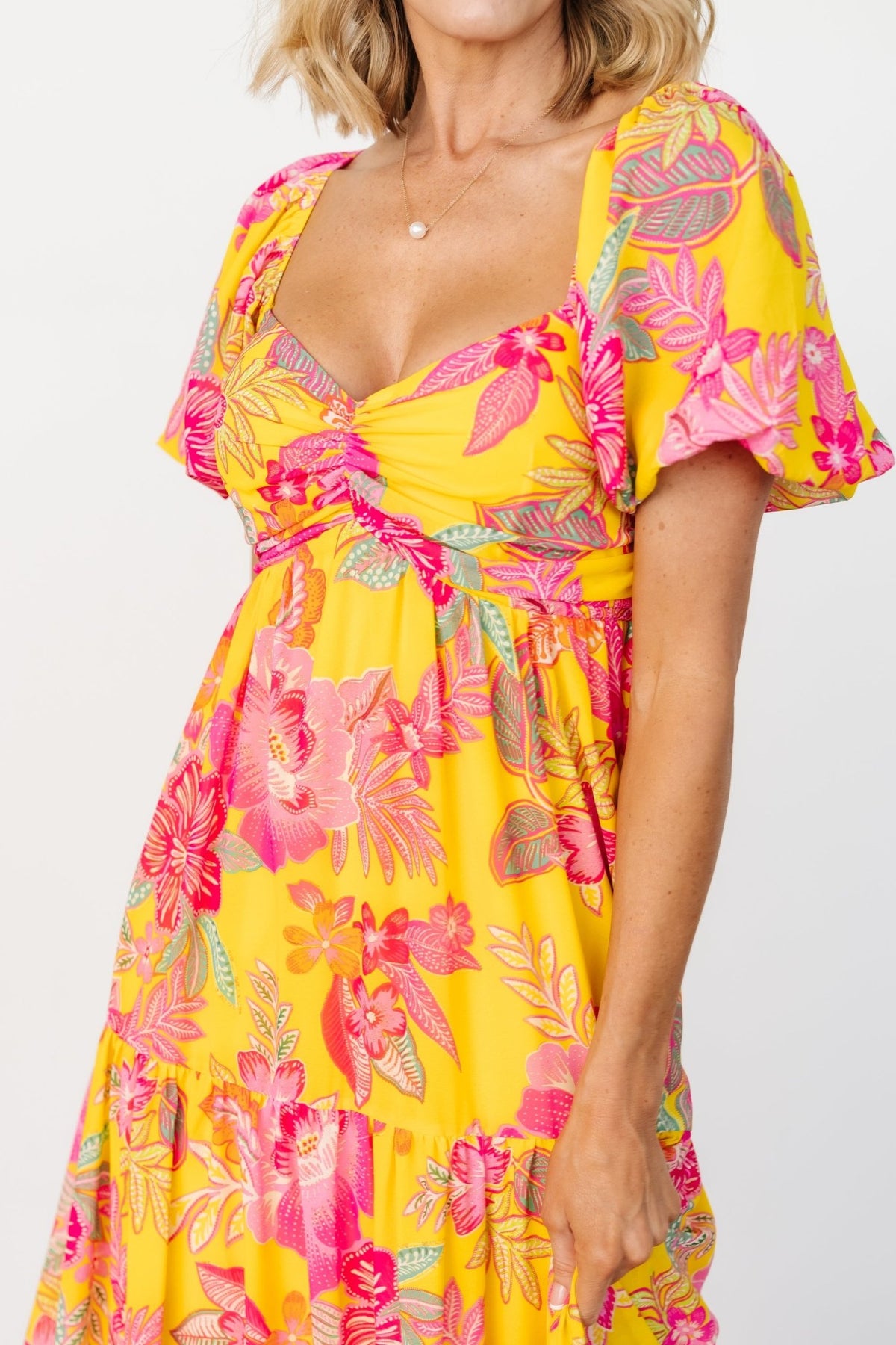 Close-up of Darla dress bodice highlighting the center-ruched bust, sweetheart neckline and short puff balloon sleeves with elastic.