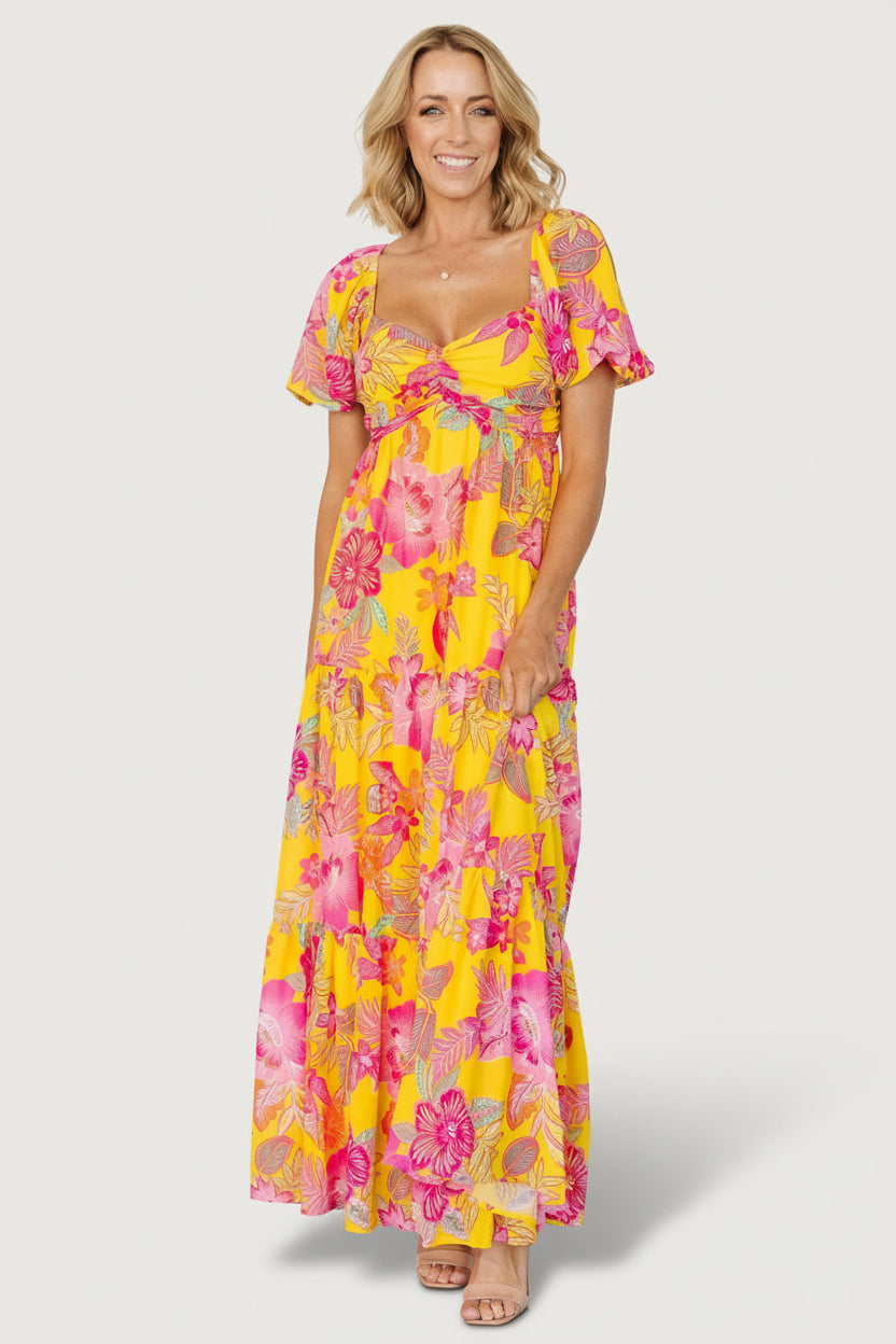 Front view of Darla floral chiffon maxi dress in yellow and pink, showing sweetheart neckline and center ruching for fit and shape.