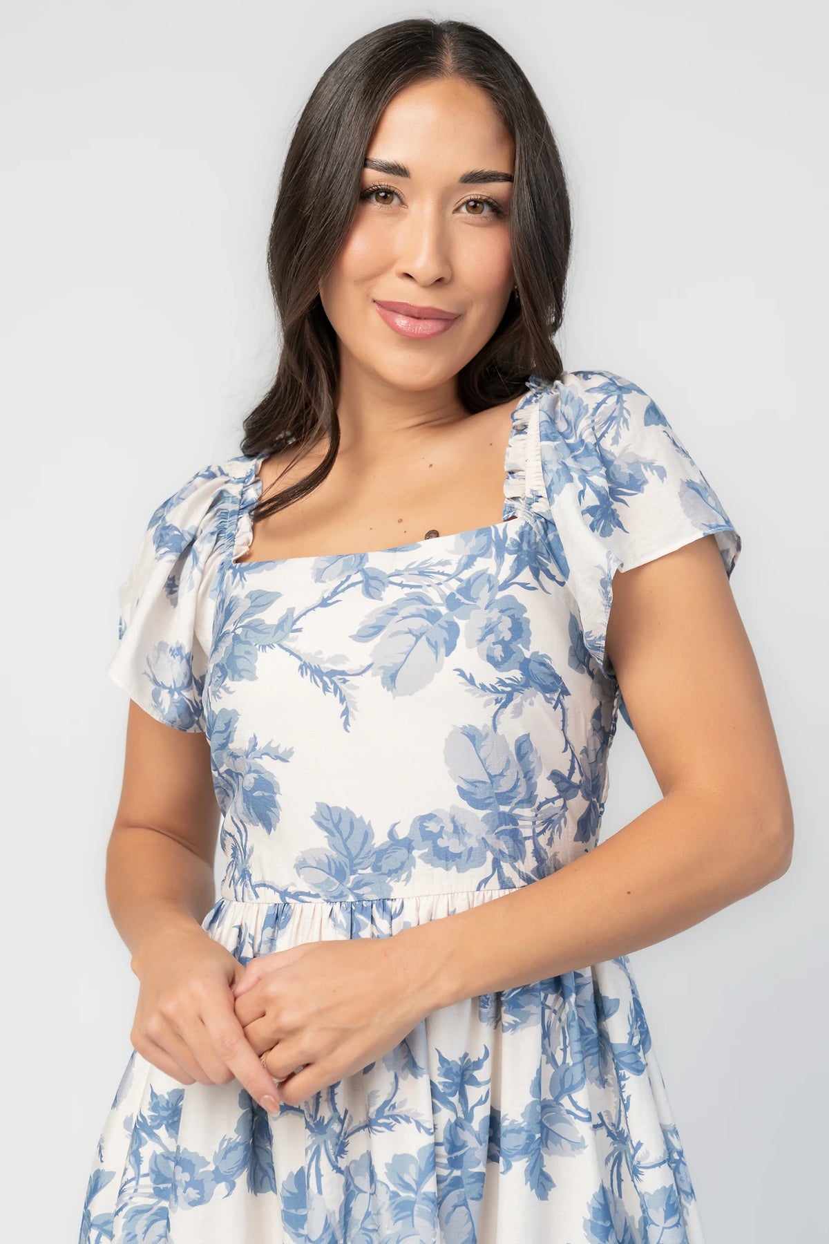 Darlene Dress in Ivory and Blue Floral with square neckline, flutter sleeves, and fit-and-flare midi skirt.