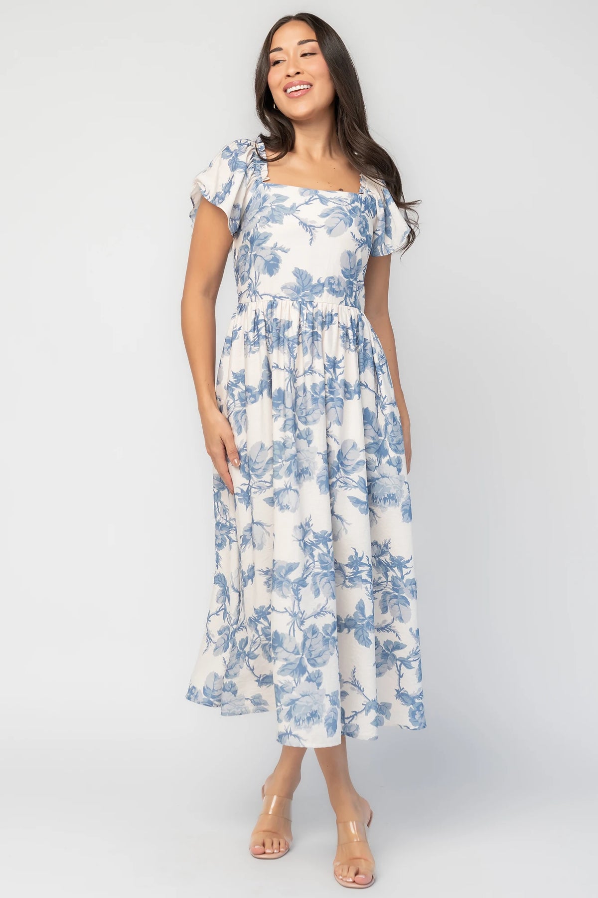 Darlene Dress in Ivory and Blue Floral with square neckline, flutter sleeves, and fit-and-flare midi skirt.