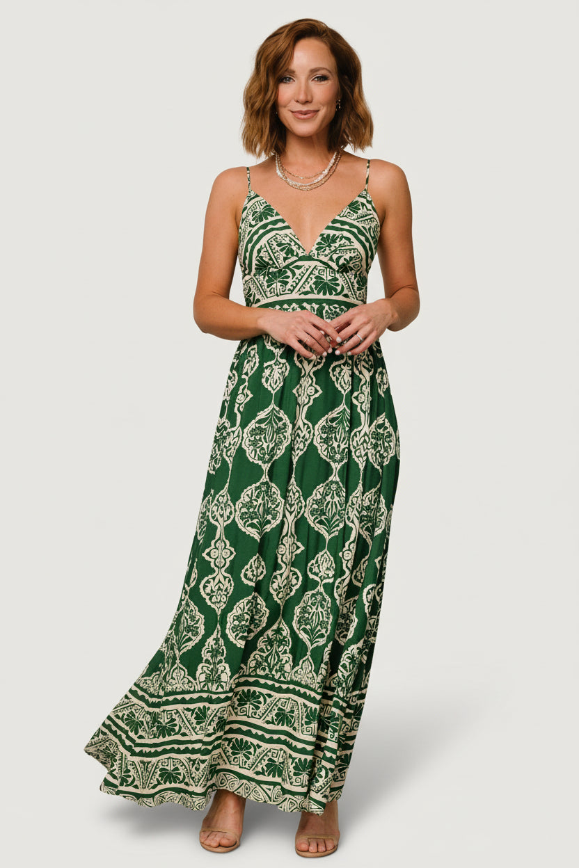 Full-length view of green-and-cream printed V-neck maxi dress on a model, showing deep V-neck, adjustable straps and flowing skirt for evening wear.