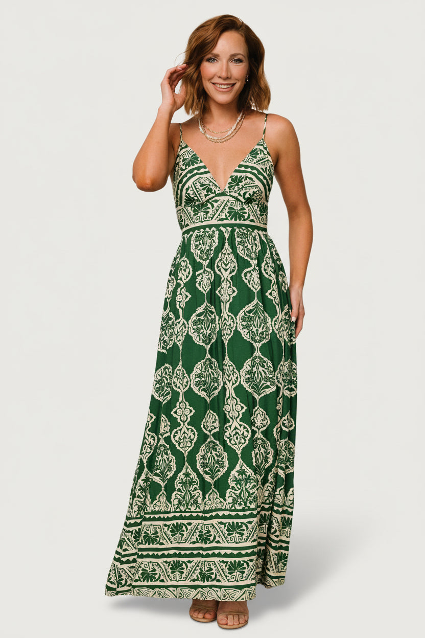 Full-body movement shot of the green print maxi dress capturing the flowy skirt and hemline as the model walks for seasonal styling.