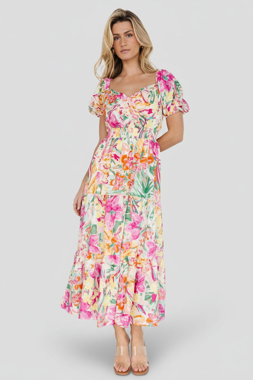 Multi-floral midi dress on cream background showing sweetheart neckline, short puff sleeves, smocked waist and tiered skirt in full view.