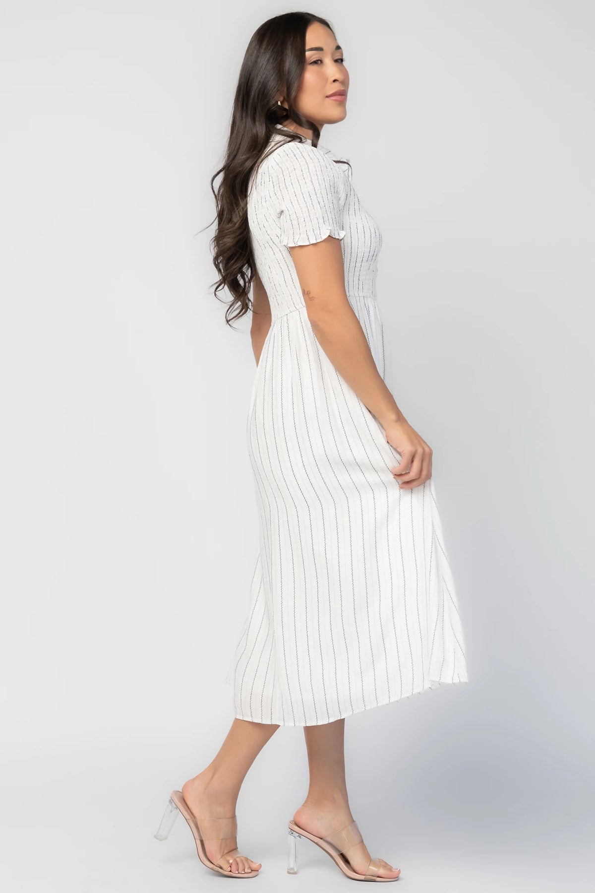 Dottie Striped Midi Dress in Off White with navy vertical stripes, collared neckline, button front, and A-line skirt.