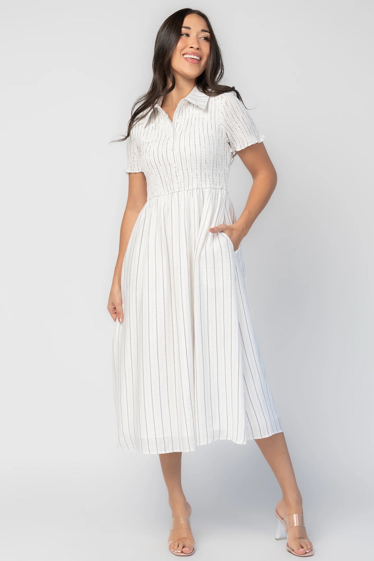 Dottie Striped Midi Dress in Off White with navy vertical stripes, collared neckline, button front, and A-line skirt.