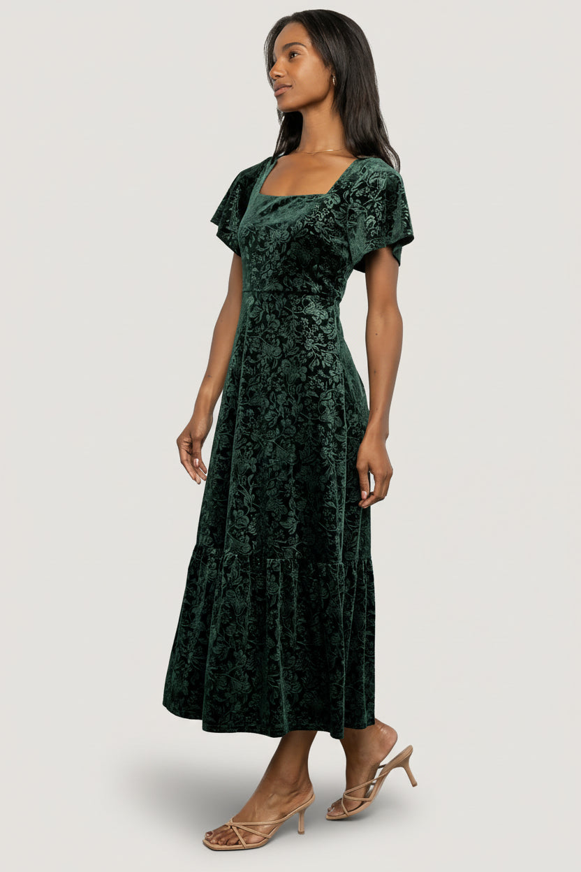 Eirene Burnout Velvet Maxi Dress in Emerald with floral velvet texture, square neckline, flutter sleeves, and tiered maxi skirt.