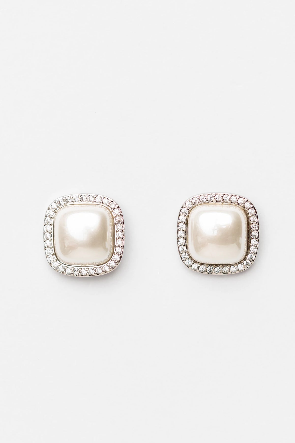 Elianna Pearl Stud Earrings in Silver with square pearl centers, clear stone borders, and polished silver-tone finish.