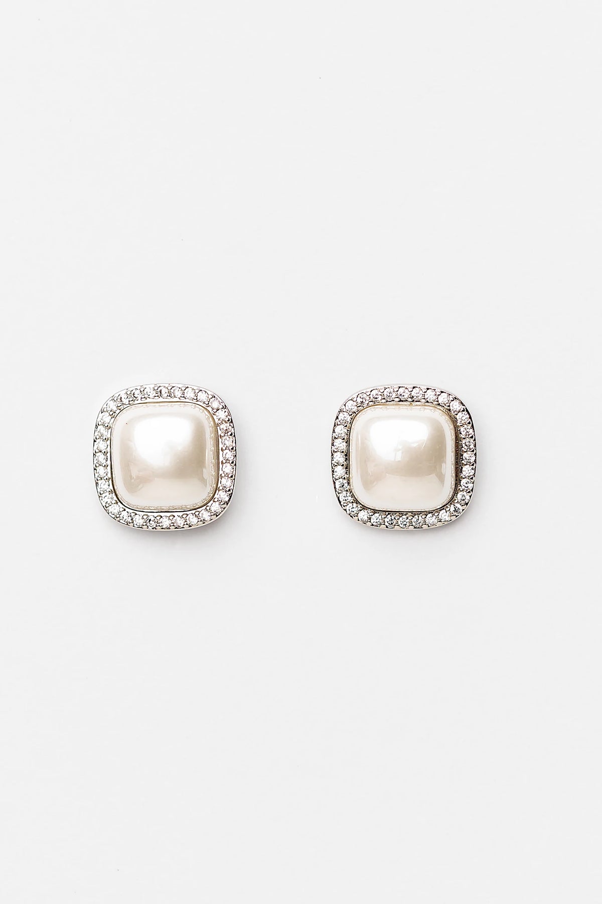 Elianna Pearl Stud Earrings in Silver with square pearl centers, clear stone borders, and polished silver-tone finish.