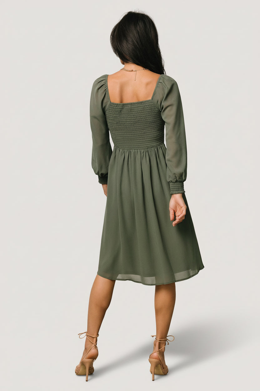 Lifestyle shot of the dark sage short dress in motion, showing sleeve movement and soft chiffon texture