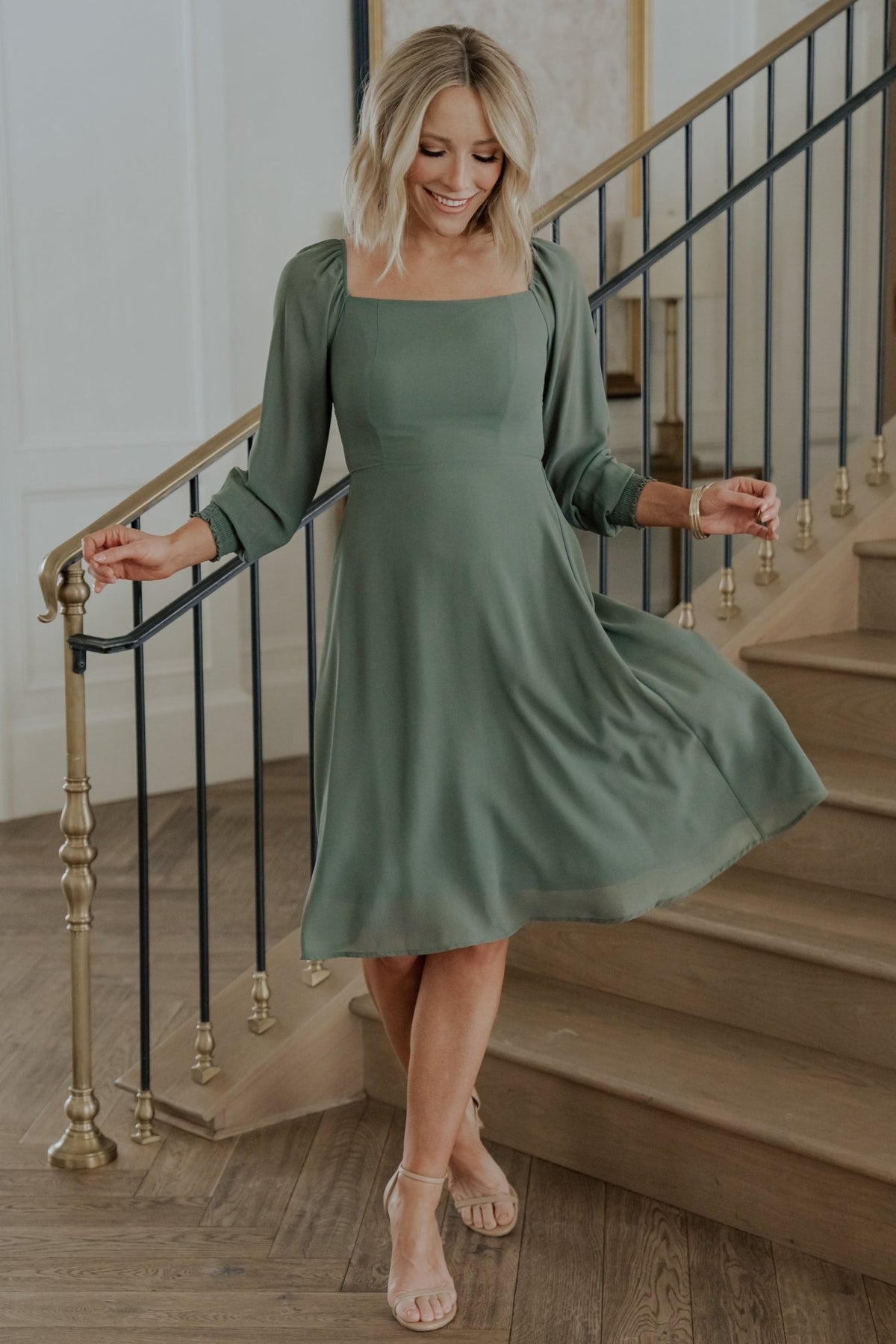 Close-up of the smocked back bodice and textured chiffon fabric in dark sage showing stretch and detail