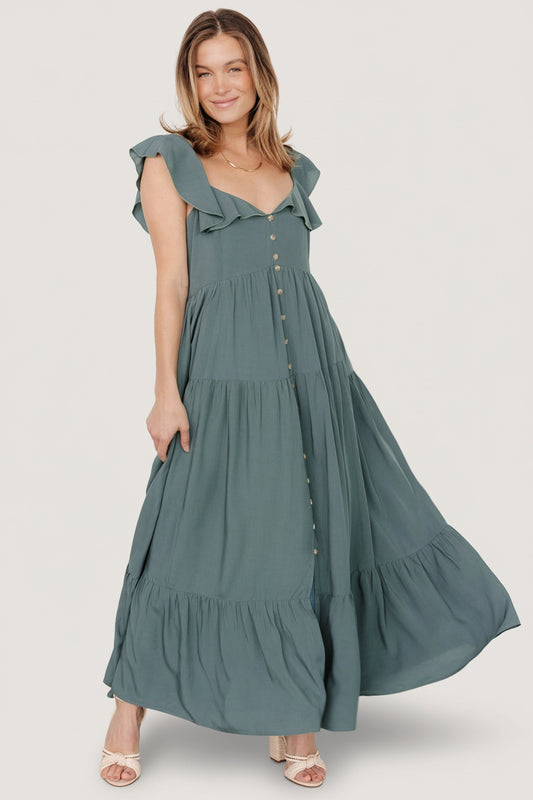 Front view of Ellie ruffle-top maxi dress in deep teal, showing ruffle V-neck, faux buttons, and tiered skirt.