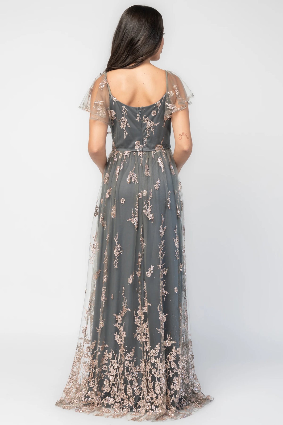 Esmerelda Shimmer Gown in Dark Sage + Rose with floral sequin embroidery, surplice V-neckline, flutter sleeves, and front slit.
