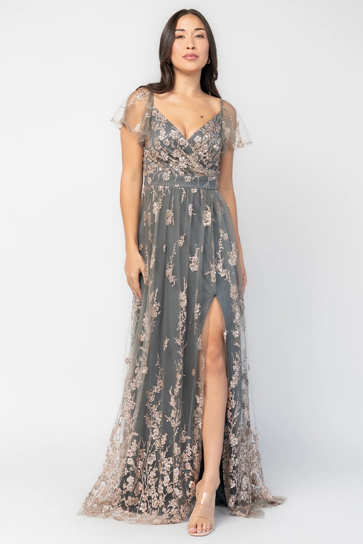 Esmerelda Shimmer Gown in Dark Sage + Rose with floral sequin embroidery, surplice V-neckline, flutter sleeves, and front slit.