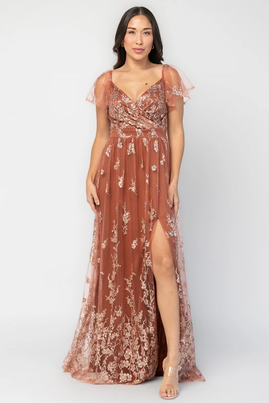 Esmerelda Shimmer Gown in Terracotta with floral sequin embroidery, surplice V-neckline, flutter sleeves, and front slit.