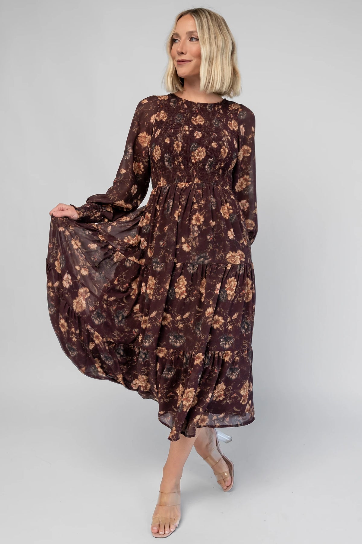 Evelyn Smocked Midi Dress in Dark Clove Floral with a smocked bodice, smocked cuffs, and a tiered midi skirt.