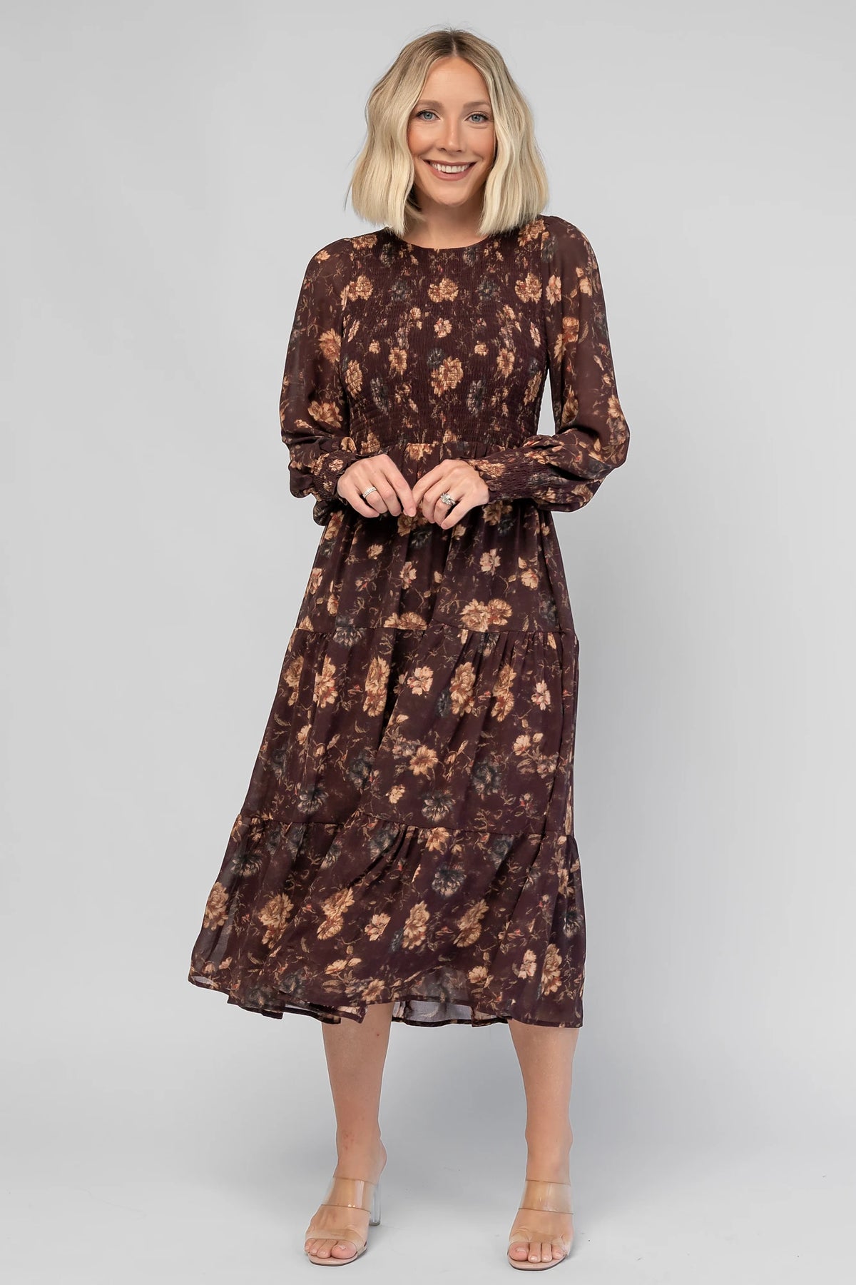 Evelyn Smocked Midi Dress in Dark Clove Floral with a smocked bodice, smocked cuffs, and a tiered midi skirt.