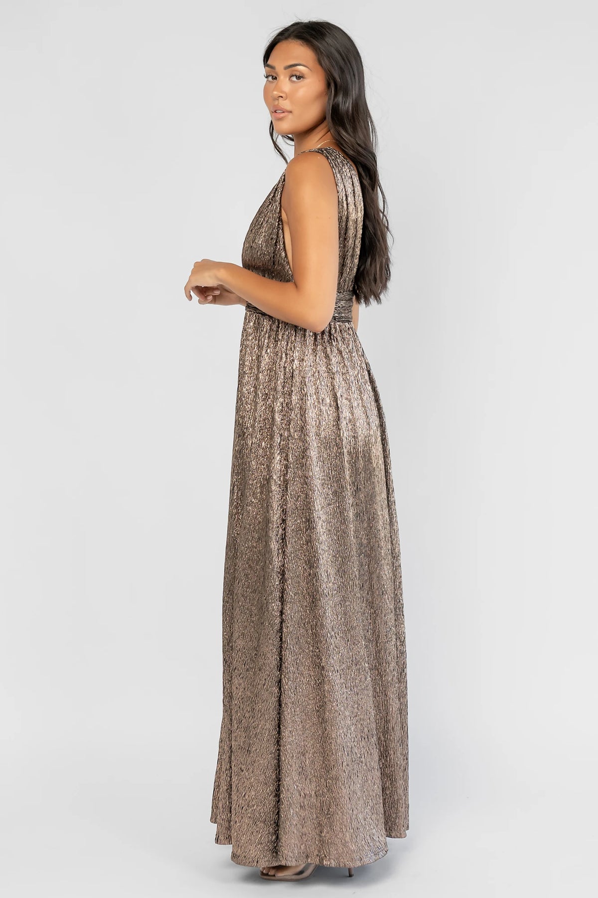 Fiora Maxi Dress in Dark Bronze with a plunging V-neckline, tank sleeves, an underbust panel, and a left leg slit.
