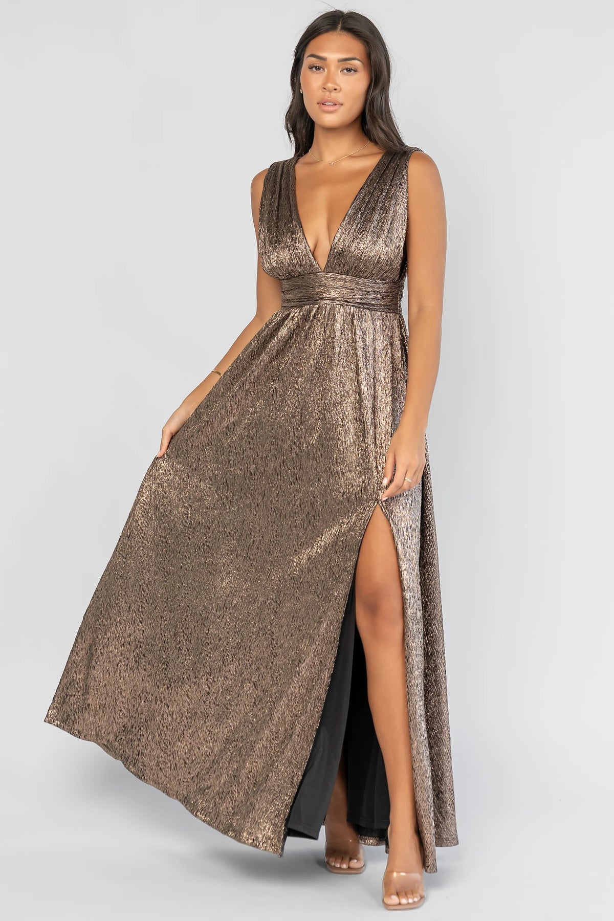 Fiora Maxi Dress in Dark Bronze with a plunging V-neckline, tank sleeves, an underbust panel, and a left leg slit.