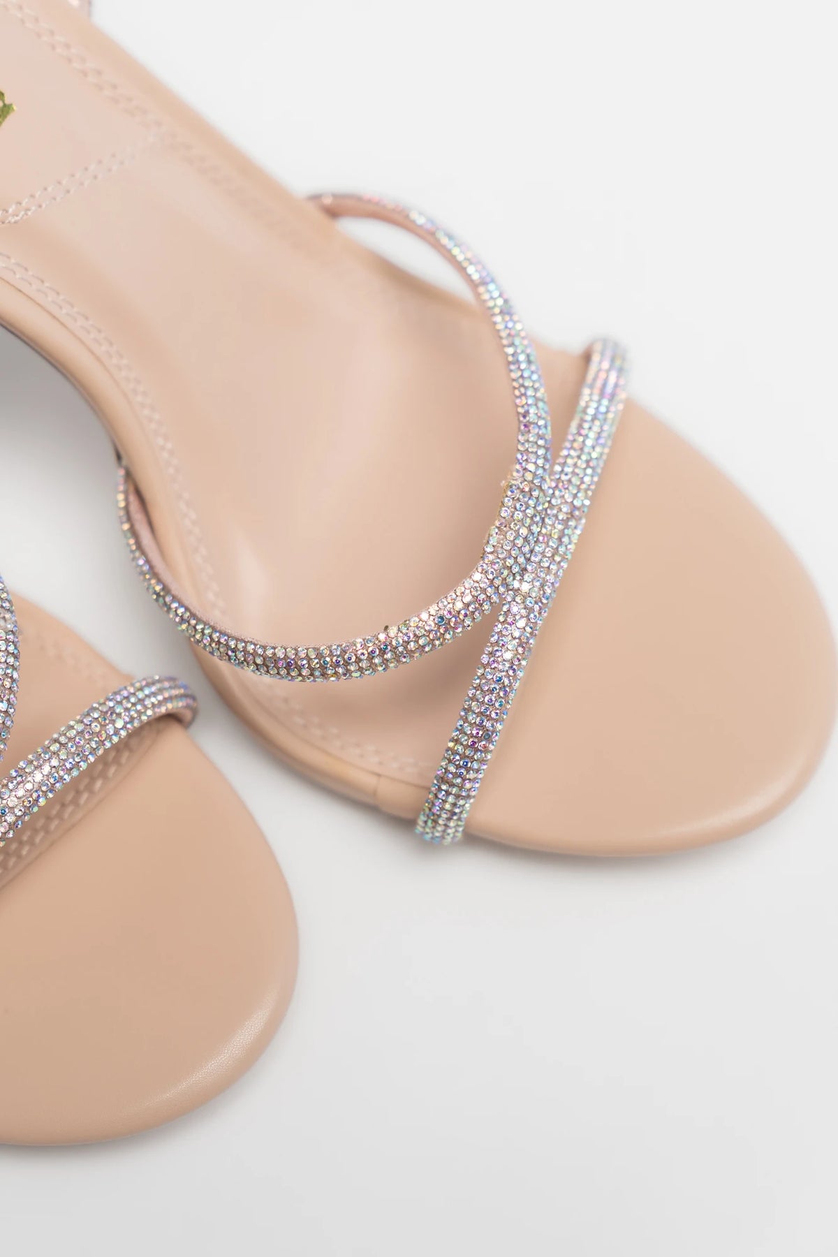 Glisten Ankle Strap Heel in Nude + Silver with rhinestone crossover straps, open toe, adjustable ankle strap, and stiletto heel.